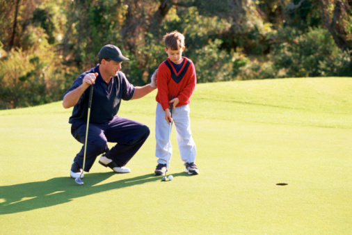 A Child Learning to Golf